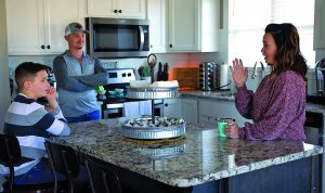 Amanda and family in their kitchen talking